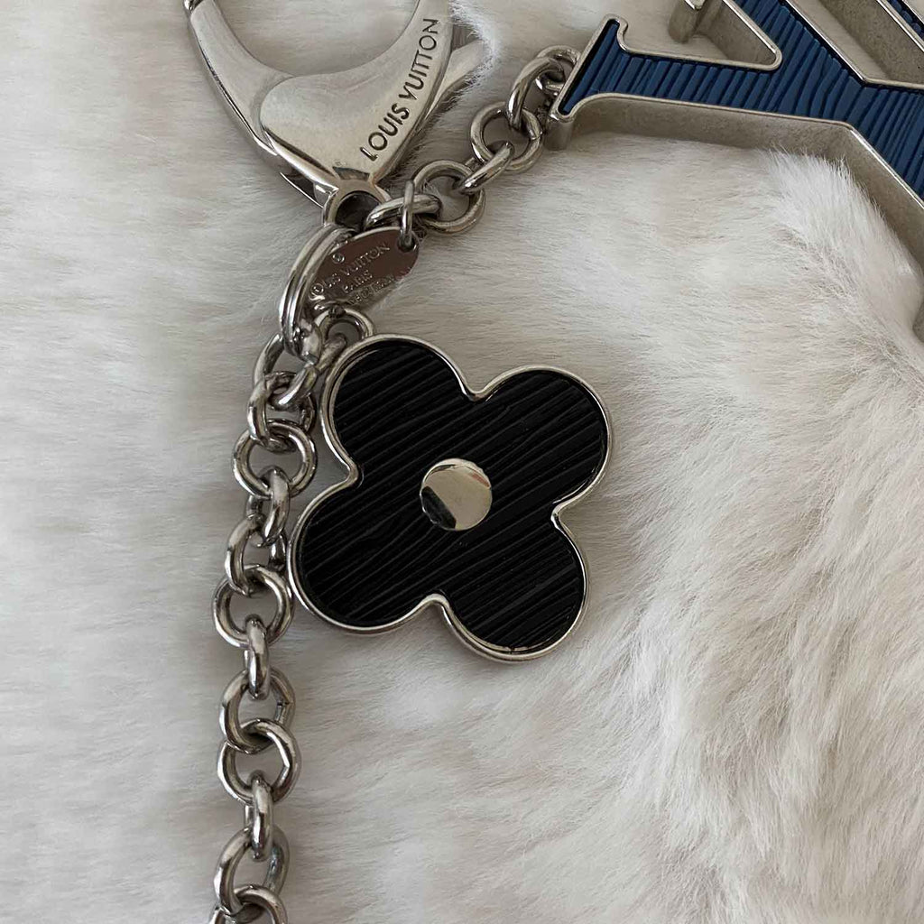 Louis Vuitton, Pochette and Fleur d'epi Bag Charm. - Bukowskis